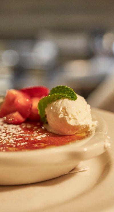 Creme brulee topped with strawberries on the 801 Chophouse dessert menu.